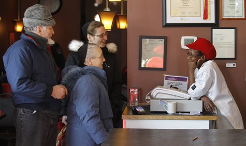 Thea Morris, right, speaks with customers in Thea's Diner in Morris, Manitoba, before Milt Stegall arrived to show support in the small community, Saturday, December 14, 2013. (TREVOR HAGAN/WINNIPEG FREE PRESS)