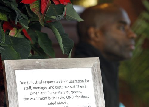 Milt Stegall behind a sign inside Thea's Diner in Morris, Manitoba. Stegall flew up from Atlanta to show support for Thea Morris in the small community, Saturday, December 14, 2013. (TREVOR HAGAN/WINNIPEG FREE PRESS)