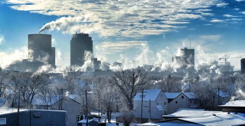 Steam rises from the buildings of Winnipeg's Downtown as seen from the Salter Street bridge Sunday morning. 131215 December 15, 2013 Mike Deal / Winnipeg Free Press