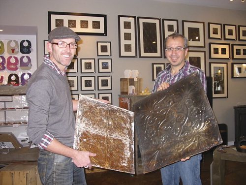 Tyler Kilkenny, left, and Todd Sawyer display old tin salvaged from abandoned farm houses that Kilkenny will turns into art pieces. The art works are on display in a gallery at TinHouse Coffee house, that Kilkenny and Sawyer recently opened in Russell. December 11, 2013. Bill Redekop story / photo. Winnipeg Free Press.