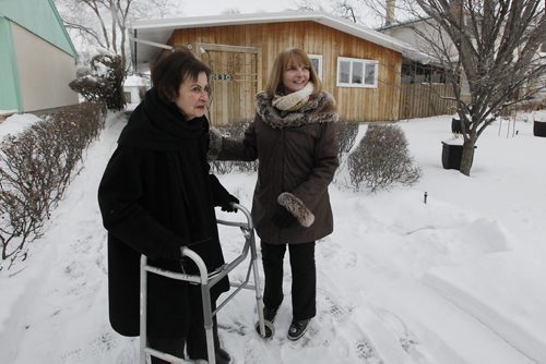 December 15, 2013 - 131215  -  Marnie Barker (R) and  Debby Lexier outside Lexier's home Sunday, December 15, 2013. Barker and Lexier first met in 1967 when Lexier came across Barker and her friend unknowingly drawing swastikas in the snow. John Woods / Winnipeg Free Press