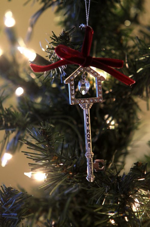 A Christmas tree ornament  in the shape of a key  with "New Home" inscribed on it and year 2013 was given to the family as a gift in honour of their new home, dangles from their newly dressed tree in the Van De Kaere families new home.  Photo Essay on the Van De Kaere family (including  Cadence, Shannon, Rene and Brendon) finally moving into their  Habitat home just  in time for Christmas.  Dec 16, 2013 Ruth Bonneville / Winnipeg Free Press