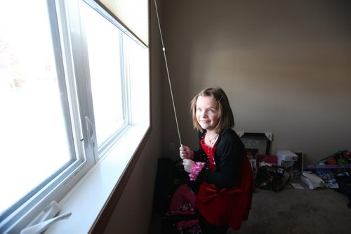 Seven year old Cadence opens the blinds to her bedroom window. Photo Essay on the Van De Kaere family (including  Cadence, Shannon, Rene and Brendon) finally moving into their Habitat home just  in time for Christmas.  Dec 16, 2013 Ruth Bonneville / Winnipeg Free Press