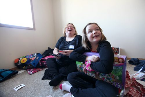 Shannon Van De Kaere  beams with joy as her daughter Cadence opens birthday gifts  on the floor of her bedroom in her new habitat  home. Photo Essay on the Van De Kaere family (including  Cadence, Shannon, Rene and Brendon) finally moving into their Habitat home just  in time for Christmas.  Dec 16, 2013 Ruth Bonneville / Winnipeg Free Press