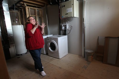 Shannon Van De Kaere can't contain her excitement as she makes her way through the basement of her Elmwood new home.  Photo Essay on the Van De Kaere family (including  Cadence, Shannon, Rene and Brendon) finally moving into their new habitat home in Elmwood. Dec 16, 2013 Ruth Bonneville / Winnipeg Free Press Habitat home just  in time for Christmas.