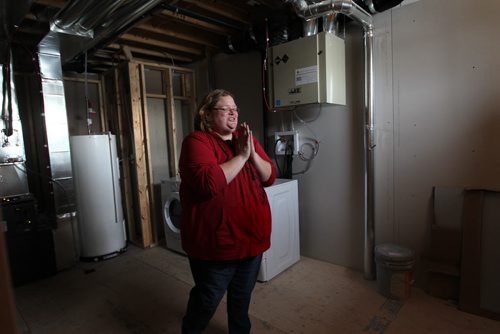 Shannon Van De Kaere can't contain her excitement as she makes her way through the basement of her Elmwood new home.  Photo Essay on the Van De Kaere family (including  Cadence, Shannon, Rene and Brendon) finally moving into their Habitat home just  in time for Christmas.  Dec 16, 2013 Ruth Bonneville / Winnipeg Free Press