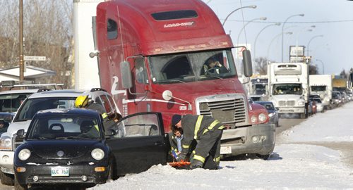 Winnipeg Fire Fighters care for one of the drivers of a multi-vehicle collision in the south bound lane of King Edward St. near Bannatyne Ave. West Tuesday afternoon. Wayne Glowacki / Winnipeg Free Press Dec.17. 2013