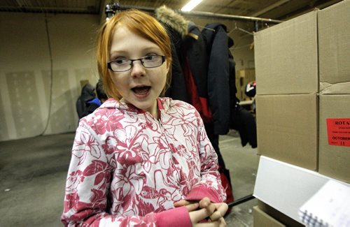 Grade four student, Ryan Redwood, 9, from Elwick Community School talks about her experience helping to make 250 hampers for the Christmas Cheer Board. 131217 - December 17, 2013 MIKE DEAL / WINNIPEG FREE PRESS
