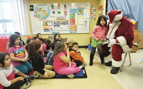 Gabriel Wilson, 5, talks to Santa as he meets with the Kindergarten and Grade one kids at the Sergeant Tommy Prince School on the Brokenhead Ojibway First Nation during the Santa Express tour.  131218 December 18, 2013 Mike Deal / Winnipeg Free Press