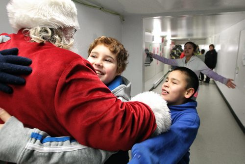 Santa greets kids at the Wanipigow school on the Hallow Water First Nation after arriving with MKO Grand Chief David Harper during the Santa Express tour.  131218 December 18, 2013 Mike Deal / Winnipeg Free Press