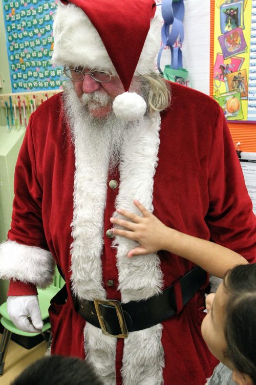Besides the impromptu hugs Santa had to deal with little hands stroking his bright red coat and fingering his oversized belt during his visit to the Black River Anishinabe School on the Little Black River First Nation with MKO Grand Chief David Harper during the Santa Express tour.  131218 December 18, 2013 Mike Deal / Winnipeg Free Press