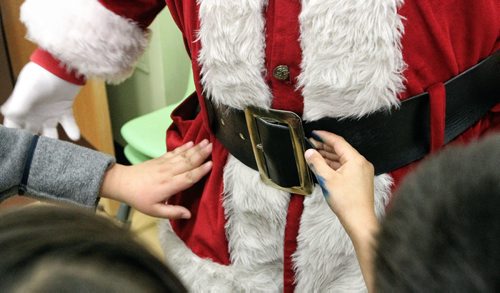 Besides the impromptu hugs Santa had to deal with little hands stroking his bright red coat and fingering his oversized belt during his visit to the Black River Anishinabe School on the Little Black River First Nation with MKO Grand Chief David Harper during the Santa Express tour.  131218 December 18, 2013 Mike Deal / Winnipeg Free Press