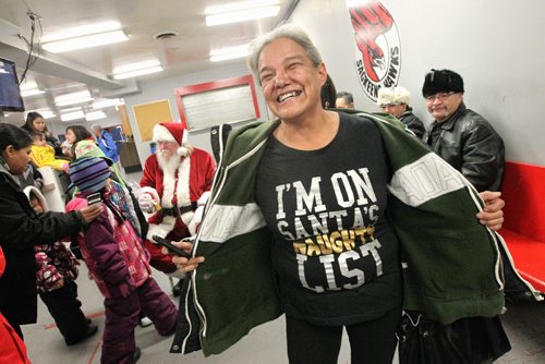 Barbara Courchene wore a special t-shirt for Santa as he visits the Sagkeeng First Nation during his Santa Express tour Wednesday.  131218 December 18, 2013 Mike Deal / Winnipeg Free Press