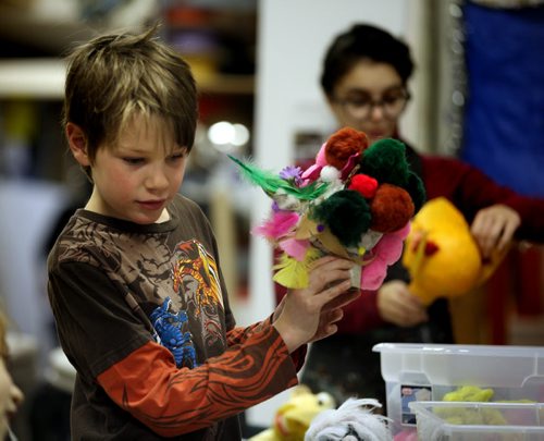 9 yr old Robert Montgomery works on his puppet Wednesday afternoon at Art City. See story. December 18, 2013 - (Phil Hossack / Winnipeg Free Press)