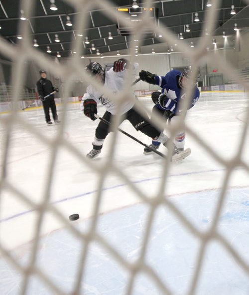 Josh Gardner a  12 A1 hockey player, front, demonstrates with Sean Lett the  ultimate self protection from a hit from behind-See Dan Lett 49.8 hockey story  Dec 19, 2013   (JOE BRYKSA / WINNIPEG FREE PRESS)