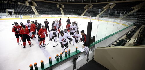 Head Coach Kevin Dineen (center) and of Team Canada women's hockey players at Ralph Engelstad Arena in Grand FOrks Thursday. See Gary Lawless story. December 19, 2013 - (Phil Hossack / Winnipeg Free Press)