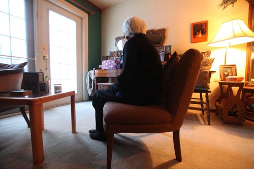 A frail elderly women sits next to her piano where a large bag of wrapped Christmas gifts were stolen from her home Friday morning while she was in her basement loading groceries from a recent trip to the store.  Two men enter her home just after she arrived home from the grocery store around 11am Friday morning and went into her living room stealing her bag of Christmas gifts and a flat screen TV.  When she came upstairs the pushed her out of the way and sped off in a waiting car.  Her identity has been withheld for her safety. See story. Dec 21, 2013 Ruth Bonneville / Winnipeg Free Press