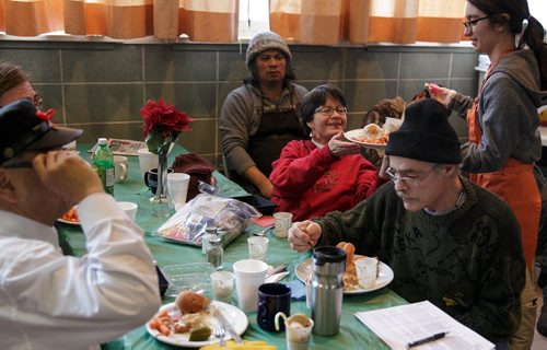 Agape Table volunteers fed hundreds during their annual Christmas meal Monday morning at All Saints Anglican Church in West Broadway. Along with the food there were piles of donated clothing handed out. Agape Table regularly runs a low-cost grocery three times a week out of the basement of the church.   131223 - Monday, {month aame} 23, 2013 - (Melissa Tait / Winnipeg Free Press)