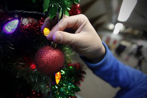 December 23, 2013 - 131217  -  Rossbrook House senior staff member Calvin Ducharme puts the finishing touches to a Christmas tree Monday, December 23, 2013. JOHN WOODS / WINNIPEG FREE PRESS