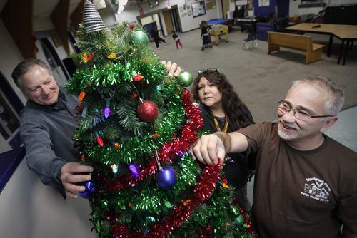 December 23, 2013 - 131217  -  Rossbrook House staff members Phil Chiappetta (L), co-executive director, Valerie Henderson, supervisor and Warren Goulet, operations manager put the finishing touches to a Christmas tree Monday, December 23, 2013. JOHN WOODS / WINNIPEG FREE PRESS