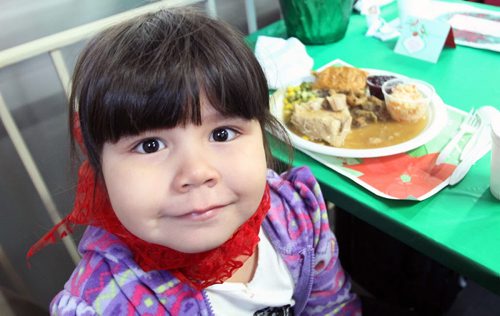 Mona Miracle, 4 yrs old enjoys Christmas Eve dinner at the Siloam Mission this afternoon- 500 guests will be served by 110 volunteers eating 95 turkeys, 450 lbs of potatoes, and 85 pies- Standup photo- Dec 24, 2013   (JOE BRYKSA / WINNIPEG FREE PRESS)