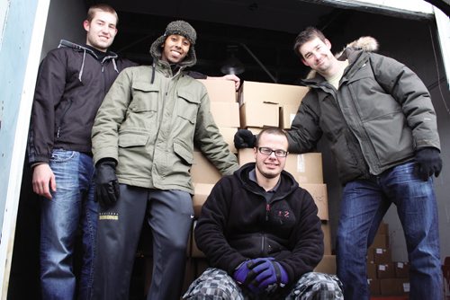 Canstar Community News (From left) Manitoba Bisons men's basketball players Brett Jewell, Amir Ali, Julian Wiebe and head coach Kirby Schepp spent some time on Siloam Mission's loading dock Thursday afternoon, preparing shipments of food. (JORDAN THOMPSON)