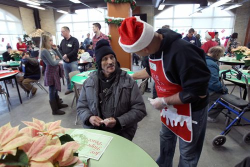 Patron Mike Szabo  is greeted by volunteer Pat Fortin at Christmas Eve dinner at the Siloam Mission this afternoon- 500 guests will be served by 110 volunteers eating 95 turkeys, 450 lbs of potatoes, and 85 pies- Standup photo- Dec 24, 2013   (JOE BRYKSA / WINNIPEG FREE PRESS)