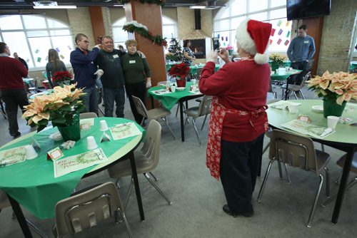 Volunteers take photos before patrons arrive at Christmas Eve dinner at the Siloam Mission this afternoon- 500 guests will be served by 110 volunteers eating 95 turkeys, 450 lbs of potatoes, and 85 pies- Standup photo- Dec 24, 2013   (JOE BRYKSA / WINNIPEG FREE PRESS)