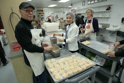 Volunteers Joe Everton, and Janice Johnson work in the kitchen with coleslaw at Christmas Eve dinner at the Siloam Mission this afternoon- 500 guests will be served by 110 volunteers eating 95 turkeys, 450 lbs of potatoes, and 85 pies- Standup photo- Dec 24, 2013   (JOE BRYKSA / WINNIPEG FREE PRESS)
