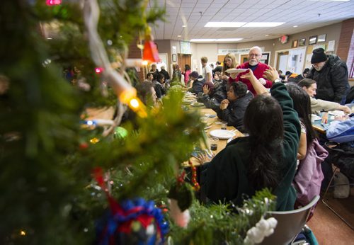 131225 Winipeg - DAVID LIPNOWSKI / WINNIPEG FREE PRESS (December 25, 2013)  Volunteer Larry Flynn serves up some Christmas cheer in the form of lunch at West Broadway Community Ministry during the annual Christmas lunch. The Shaarey Zedek Synagogue brought in food and volunteers to feed about 150 people.