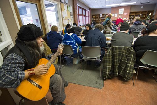 131225 Winipeg - DAVID LIPNOWSKI / WINNIPEG FREE PRESS (December 25, 2013)  Gordon Kent plays guitar as volunteers serve up some Christmas cheer in the form of lunch at West Broadway Community Ministry during the annual Christmas lunch. The Shaarey Zedek Synagogue brought in food and volunteers to feed about 150 people.