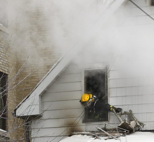 Winnipeg Fire Fighters at the scene of a fire in a two storey house in the 200 block of Beverley St. Friday afternoon. Adam Wazny story Wayne Glowacki / Winnipeg Free Press Dec.27. 2013