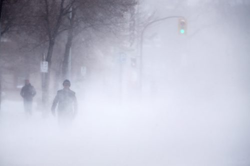 A pedestrian walks southbound on Hargrave Street towards Portage Avenue through blowing snow, Saturday, December 28, 2013. (TREVOR HAGAN/WINNIPEG FREE PRESS)