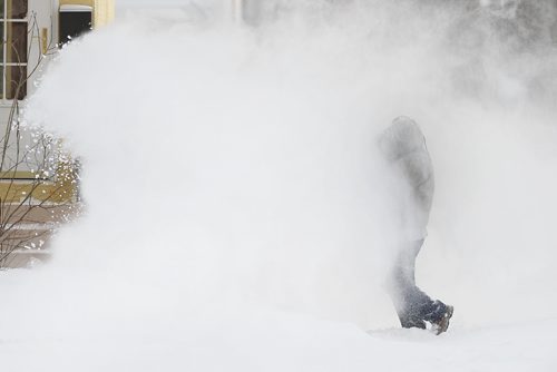 December 28, 2013 - 131228  -   A man blows snow at his home on Warsaw Avenue Saturday, December 28, 2013. John Woods / Winnipeg Free Press