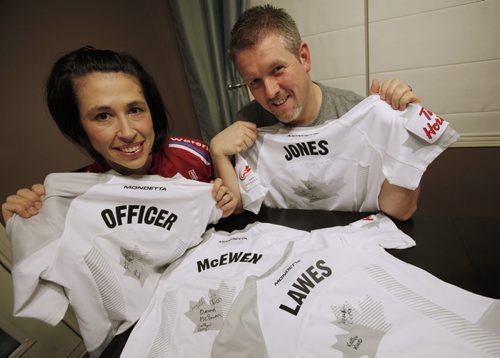 December 29, 2013 - 131229  -   Jill Officer and her husband Devlin with team jersey's that are on auction Sunday, December 29, 2013. John Woods / Winnipeg Free Press