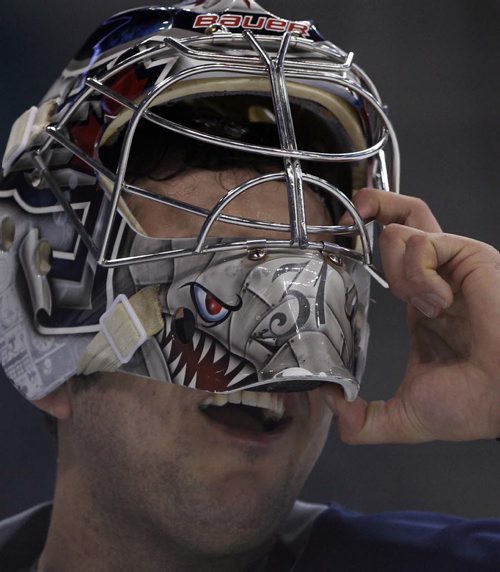 Winnipeg Jets goaltender Ondrej Pavelec adjusts his mask at practice Monday afternoon at the MTS Centre  - The Winnipeg Jets are in preparation for a home game tomorrow night against the Buffalo Sabers - Standup photo- Dec 30, 2013   (JOE BRYKSA / WINNIPEG FREE PRESS)