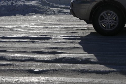 Icy rutted patches on Logan Ave. near Hwy. 90 Monday. For story Wayne Glowacki / Winnipeg Free Press Dec.30. 2013
