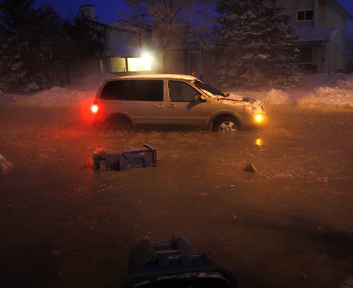 A vehicle stuck in a flooded section of Jefferson Ave. near Adsum Drive after a major water main break Tuesday morning. Wayne Glowacki / Winnipeg Free Press Dec.31. 2013