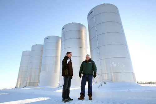 John Preun, right, and his brother Hubert in front of large fertilizer storage tanks on their farm north of Winnipeg.  For a story on how a steep drop in fertilizer prices since last summer has enabled some Manitoba farmers to save big bucks on their crop-input costs for next year.  See Murray McNeil story- Dec 31, 2013   (JOE BRYKSA / WINNIPEG FREE PRESS)
