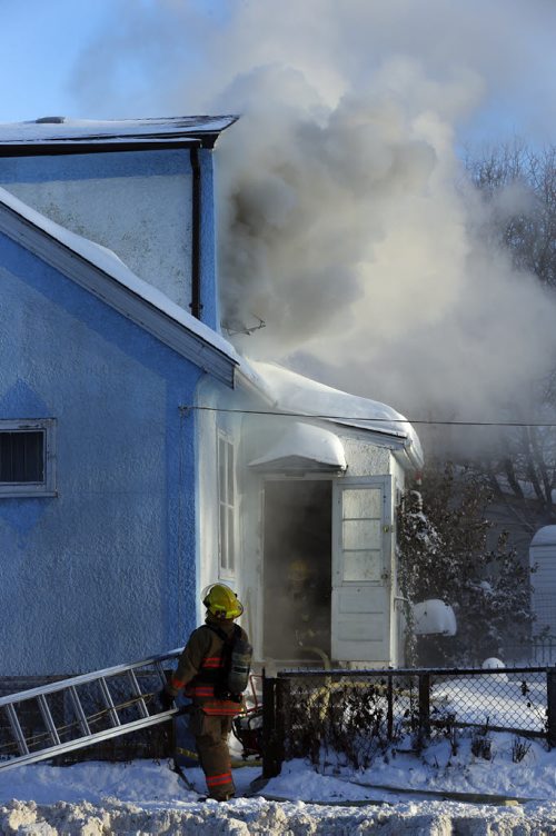 House Fire 406 Manitoba Ave. At Salter St. just before 3pm Tuesday  - The fire broke out in the second floor of the two story house , heavy smoke billowed from the house and WFS quickly put the fire out  and  there are no injuries , Dec. 31 2013 / KEN GIGLIOTTI / WINNIPEG FREE PRESS