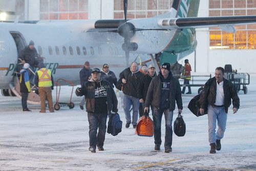 December 31, 2013 - 131231  -  Manitoba Hydro workers arrive back in Winnipeg Tuesday, December 31, 2013 after helping to restore power in Toronto after an ice storm.  John Woods / Winnipeg Free Press