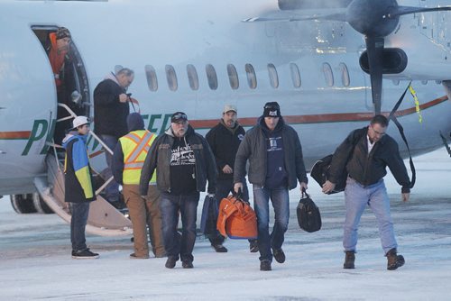 December 31, 2013 - 131231  -  Manitoba Hydro workers arrive back in Winnipeg Tuesday, December 31, 2013 after helping to restore power in Toronto after an ice storm.  John Woods / Winnipeg Free Press