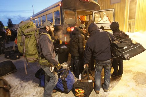December 31, 2013 - 131231  -  Manitoba Hydro workers load gear onto buses as they arrive back in Winnipeg Tuesday, December 31, 2013 after helping to restore power in Toronto after an ice storm.  John Woods / Winnipeg Free Press