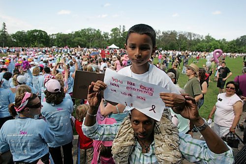 BORIS MINKEVICH / WINNIPEG FREE PRESS  070610 Walkers march into Assiniboine Park for the closing ceremonies of the breast cancer fund raiser. Jayden Ramjohn,8, sits on his dad Nigel's shoulders to support his mom Jennifer who walked the walk.