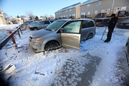 Harry Codaman holds a pick axe in his hand next to his van that is stuck in ice along with many other vehicles after a  major water main break on New Years Eve Day on Jefferson. Jan 01, 2014 Ruth Bonneville / Winnipeg Free Press