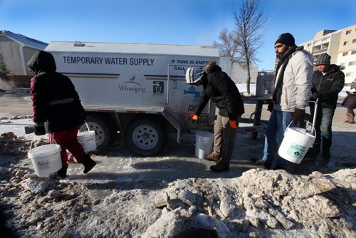 Residents living near water main break off  Jefferson Ave line up to fill water jugs  at a temporary water supply station after  major water main break on New Years Eve Day.  Jan 01, 2014 Ruth Bonneville / Winnipeg Free Press