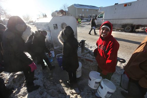 Paramjeet Lal still smiles as she waits in line to get a couple pails of water on  Jefferson Ave at a temporary water supply station set up for people living in the area of a major water main break. Jan 01, 2014 Ruth Bonneville / Winnipeg Free Press