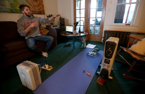 Nathan Johns, 27, a resident at a Maryland Street apartment building that is without heat after the boiler failed, Wednesday, January 1, 2014. (TREVOR HAGAN/WINNIPEG FREE PRESS)