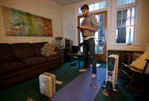Nathan Johns, 27, a resident at a Maryland Street apartment building that is without heat after the boiler failed, Wednesday, January 1, 2014. (TREVOR HAGAN/WINNIPEG FREE PRESS)