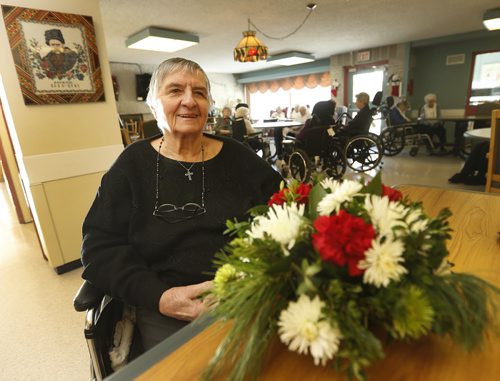 In photo Holy Family  Home resident Katherine Skotnicki  with flowers  she and other received . A truck load of free flowers were donated to Holy Family Home on Aberdeen by an anonymous donor. Story by Jordan Power  JAN. 2 2014 / KEN GIGLIOTTI / WINNIPEG FREE PRESS